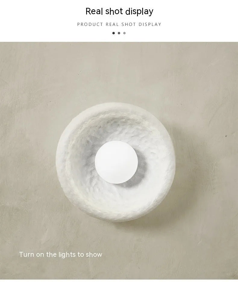 Japanese-style minimalist wall lamp with resin shade in three diameter options on modern interior wall