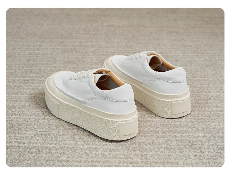 Women's black and white platform casual sports shoes with cowhide leather upper and round toe.