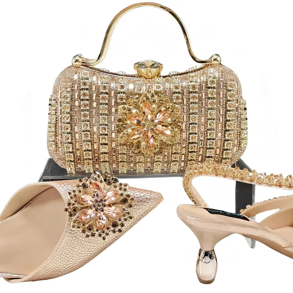 Women's black synthetic leather high heels with ankle chain and matching clutch bag with rhinestone flower decoration