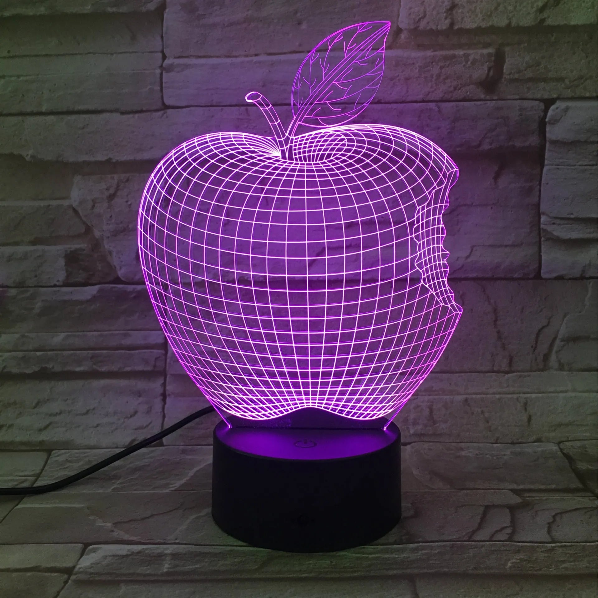 Colourful 3D fruit shaped night light with touch control on a table.