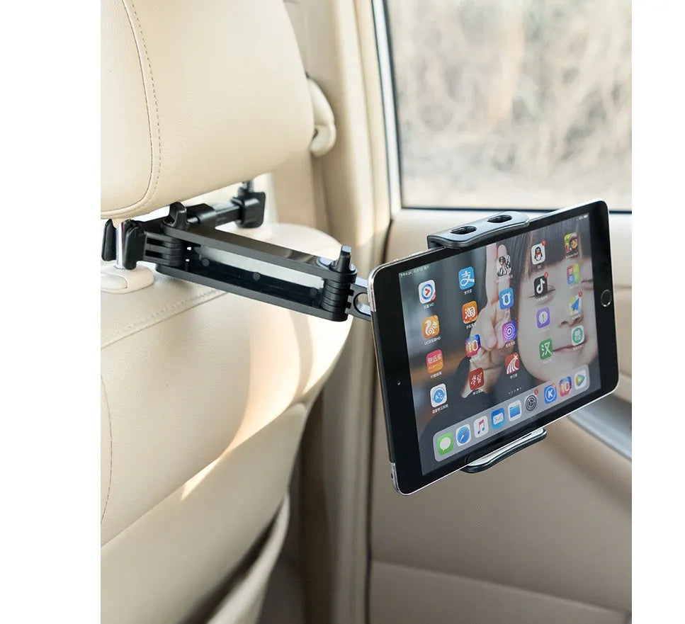 Black car phone holder mounted on vehicle rear seat base with tablet device secured in place