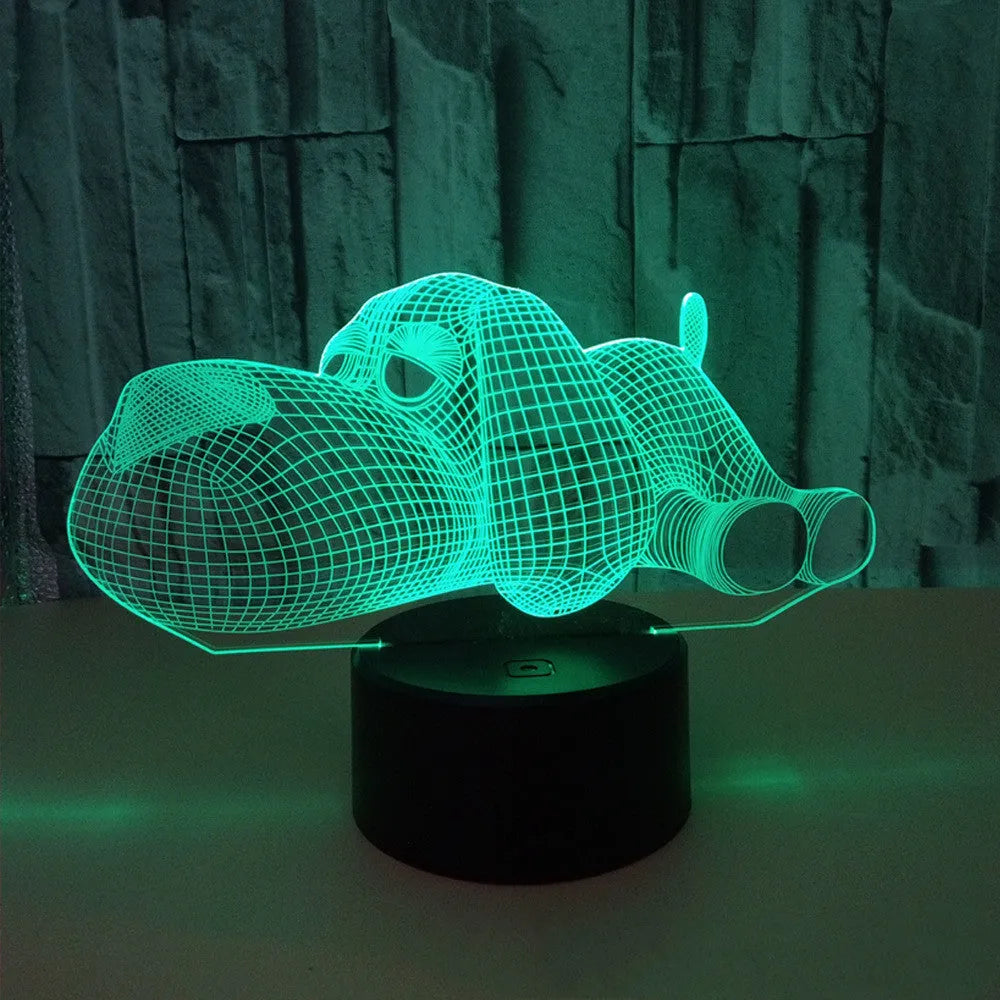 Dog-shaped 3D desktop lamp glowing in multiple colours on a wooden surface.