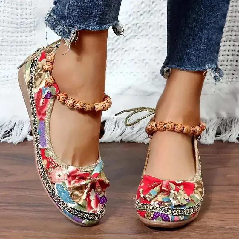 Women's plus size black ethnic platform sandals with elastic band and cloth upper.