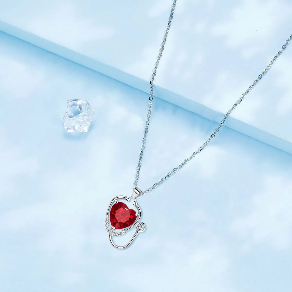 Women's copper necklace with stethoscope charm featuring wings and cross design in red diamond colour
