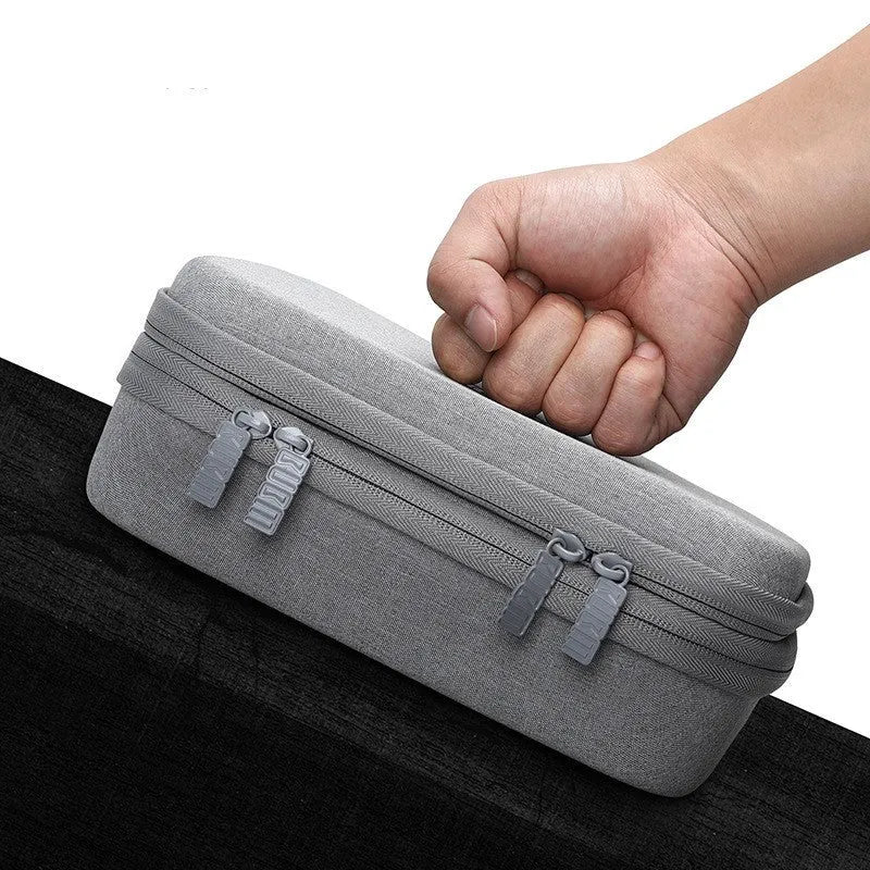 Black and grey EVA digital storage bag with handbag shape for organising headphones and cables.