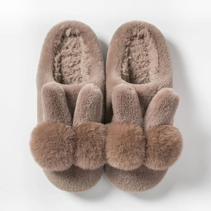 Women's fluffy bunny slippers in pink with rabbit fur, high-top sleeve design, and sewn sole.