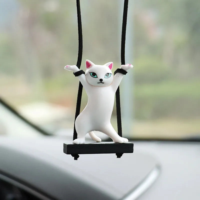 Cartoon style resin cat pendant on a rope for hanging in a car, shown in multiple colour options.