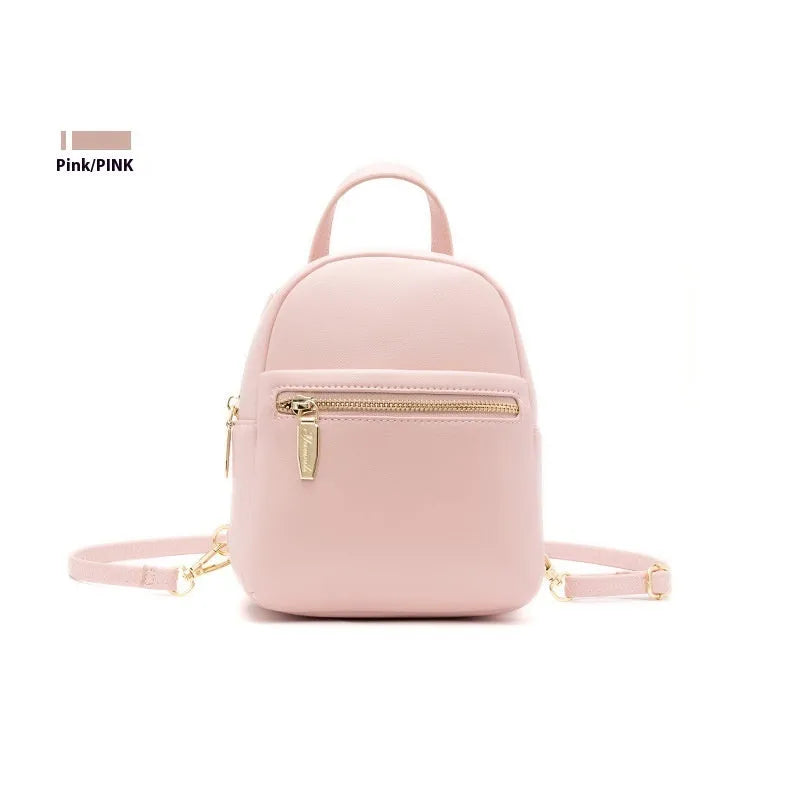 Soft black PU mini backpack with front pockets, shown open to reveal internal mobile phone sleeve and zipper compartment.