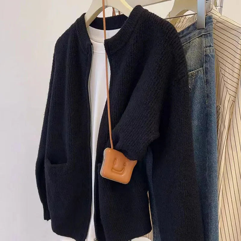 Beige soft viscose knit cardigan with long sleeves shown on a hanger.