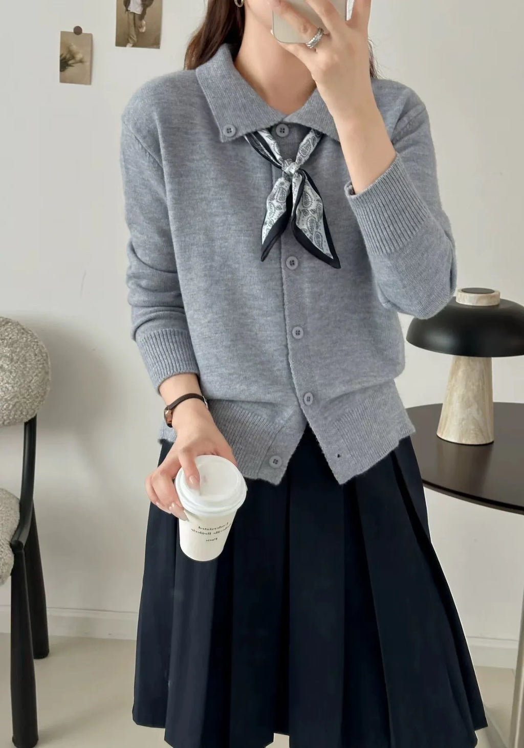 Women's beige lapel scarf collar acrylic cardigan sweater on a hanger.