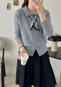 Women's beige lapel scarf collar acrylic cardigan sweater on a hanger.