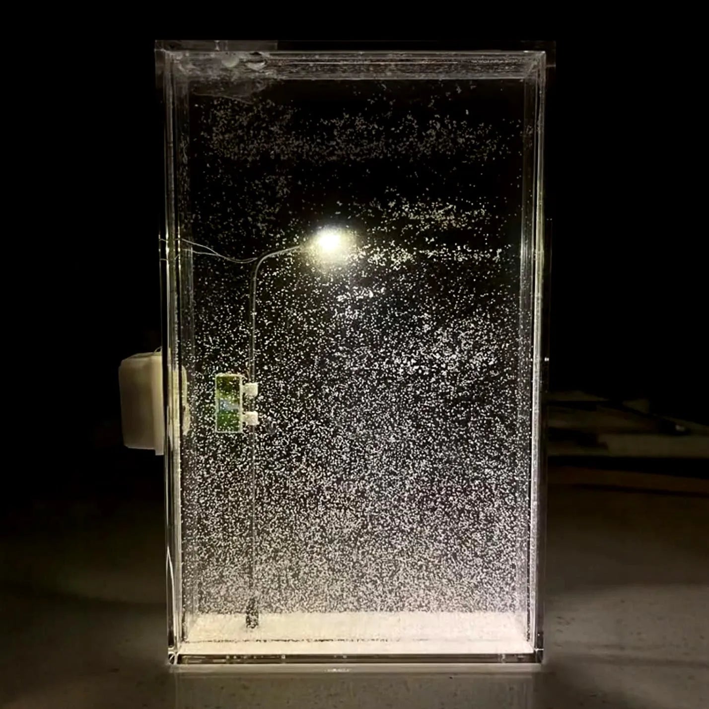 DIY snowy landscape Christmas night light kit with LED lights and gift bag on a desktop