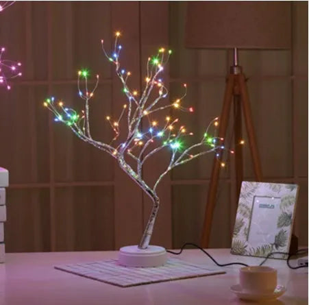 White LED Christmas tree shaped night light with touch base, standing 50cm tall on a table.