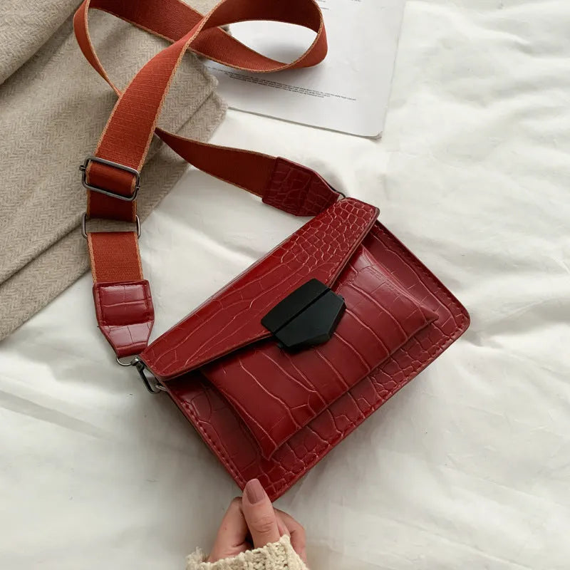 Vintage PU crossbody bag in black, shown with adjustable strap and open to reveal polyester lining.