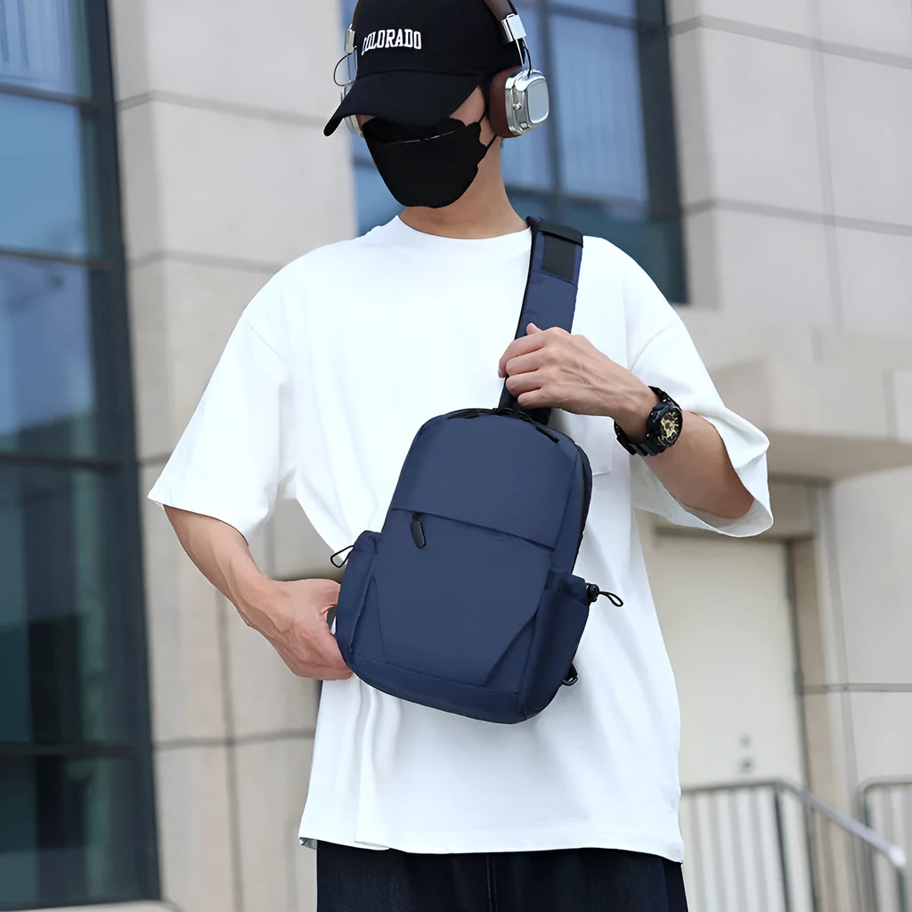 Men's grey lightweight chest bag with large main compartment and shoulder strap.