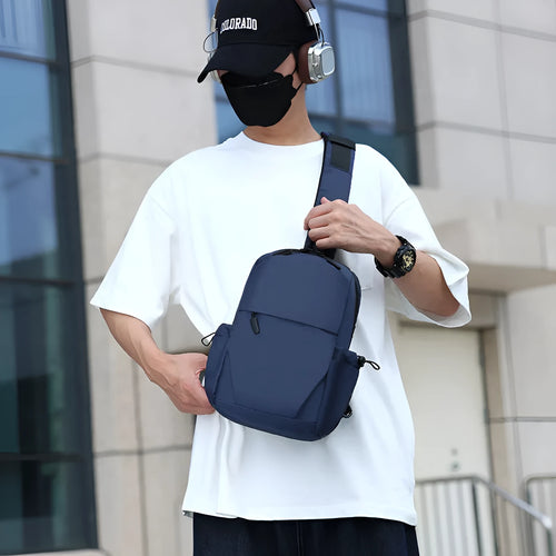 Men's grey lightweight chest bag with large main compartment and shoulder strap.
