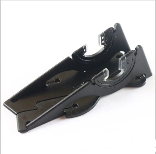 Black plastic card-type mobile phone holder propping a smartphone on a desktop