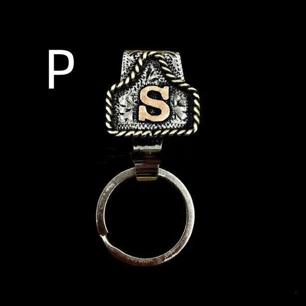Handmade metal cow tag belt key holder keychain on a key ring, showing the metal loop and tag design.
