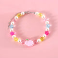 Colourful plastic pearl bead cat necklace with small flower, rainbow, or peach designs on a white background.