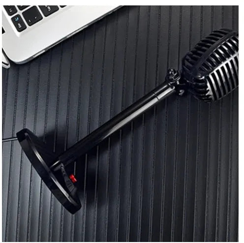 Black USB computer microphone with adjustable stand on desktop for recording