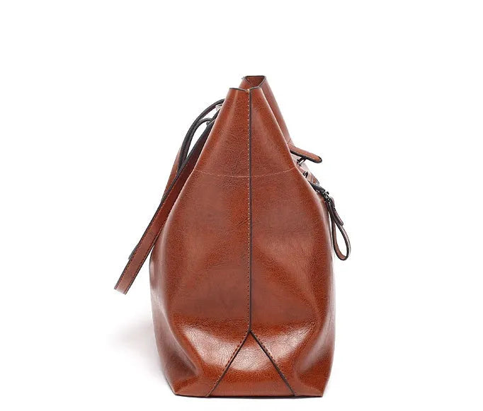 Cowhide leather cross-body handbag showing internal compartments and mobile phone pocket