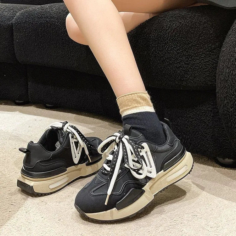 Women's black retro platform lace-up sneakers with a round toe and rubber sole.
