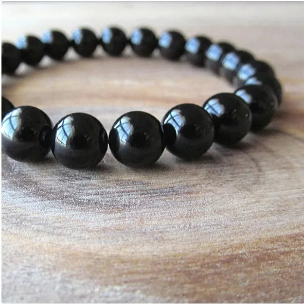Geometric black agate stretch bracelet with 8mm beads on an elastic cord.