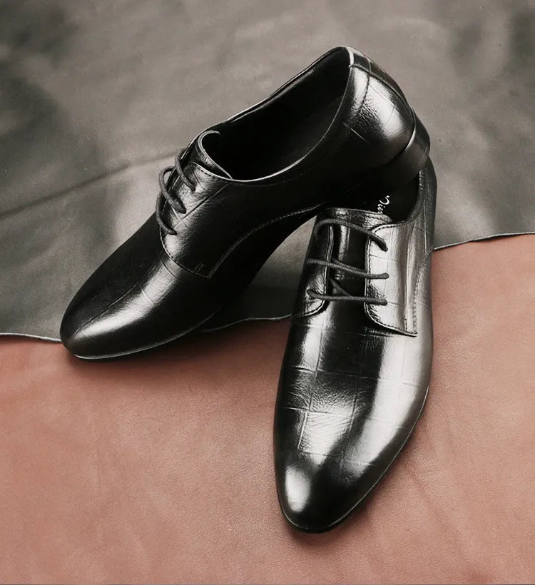 Men's black leather derby shoes with pointed toe and checkered pattern on a white background.