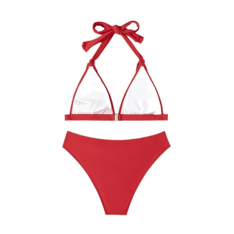 Red women's lace-up halterneck bikini set with split-leg shorts for beach swimming