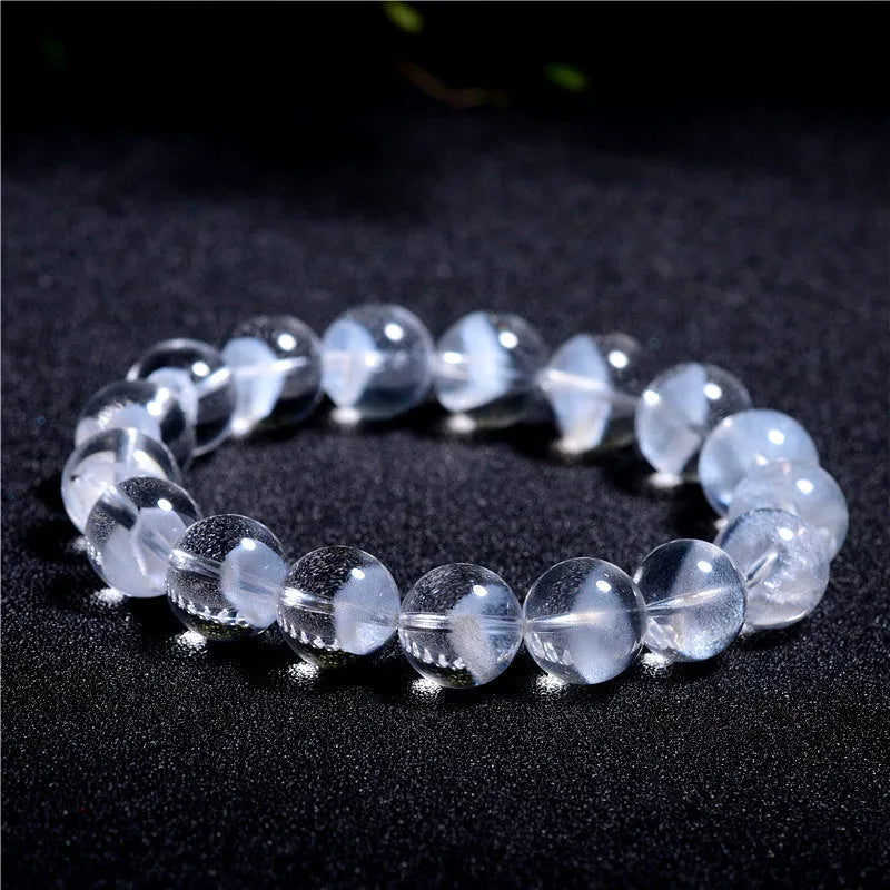 Women's natural white crystal pyramid ghost bracelet with Ruyi charm showing bead texture