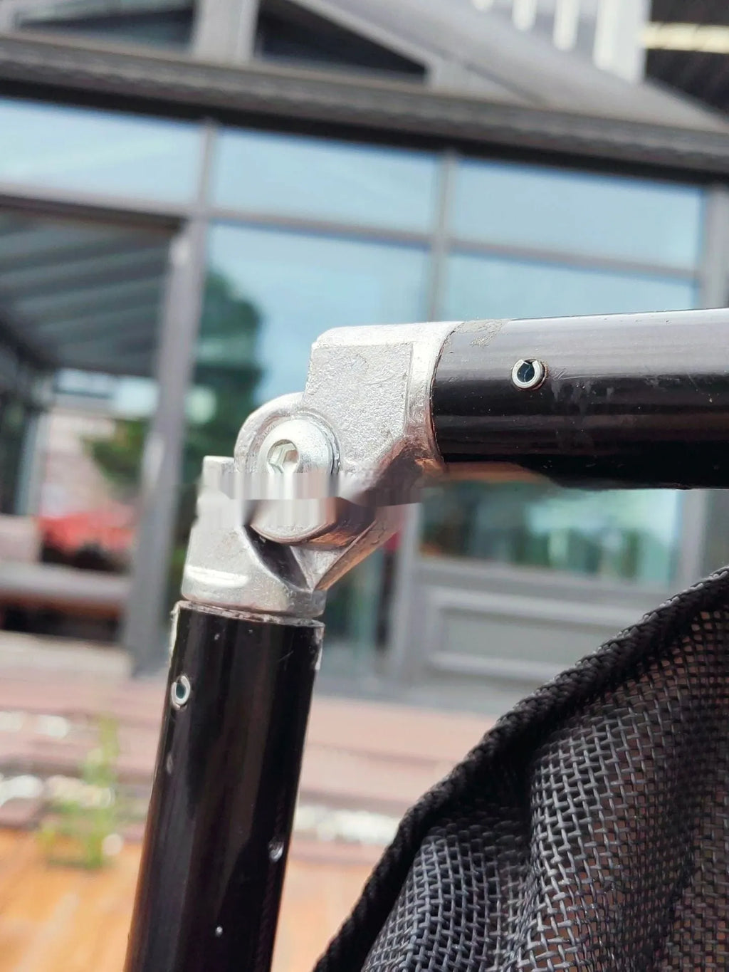 Large black aluminium alloy foldable pet stretcher unfolded on the ground for dog emergency transport.