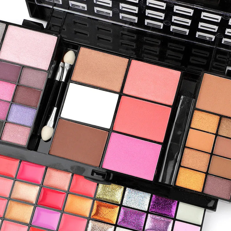 74-colour makeup palette open showing eyeshadows, lip glosses, and face powders with included brushes