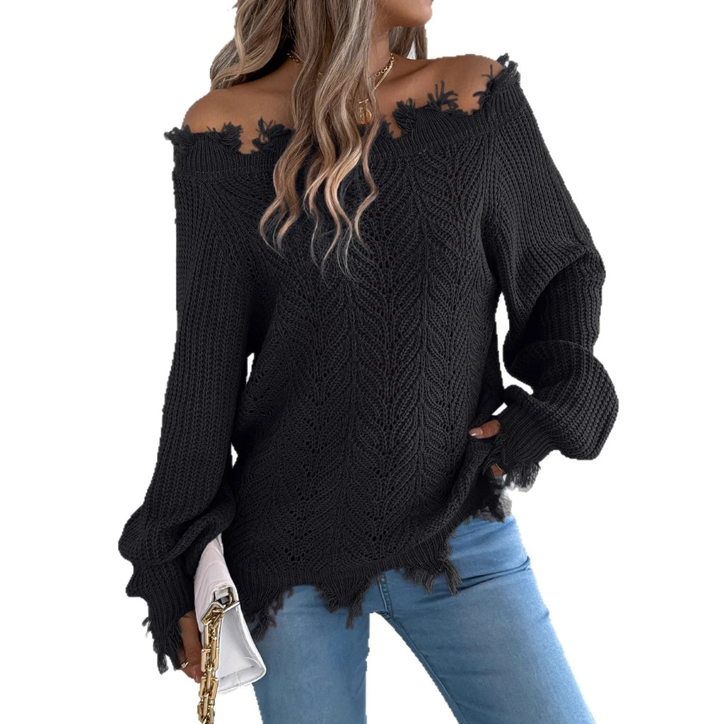 A woman wearing a white hollow-out cut off-the-shoulder pullover sweater in a street fashion style.