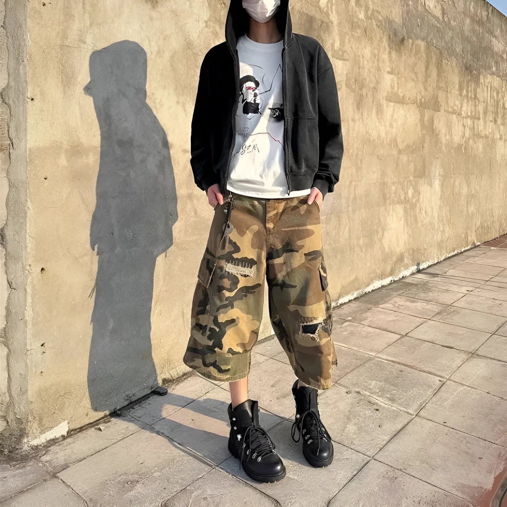 Men's camouflage cropped jeans with patchwork detailing and distressed rips in loose straight-leg fit
