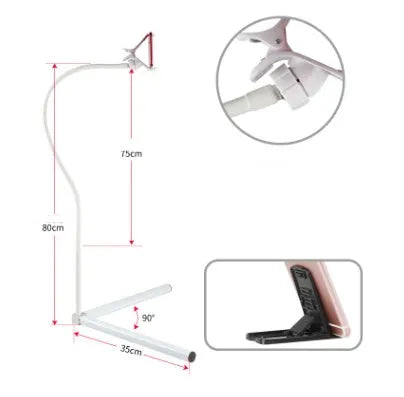 A black mobile phone bed bracket clipped to a bed frame, holding a smartphone in an overhead viewing position.
