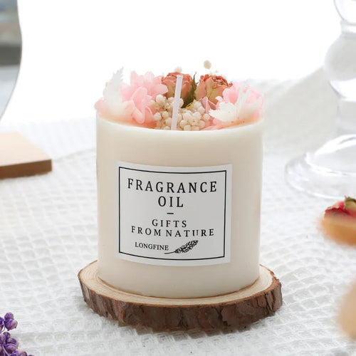 Decorative aromatherapy candle with dried flowers embedded in solid wax, shown with optional wooden chip base.