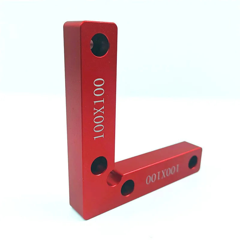 Aluminum alloy woodworking right angle positioning block on a workbench.