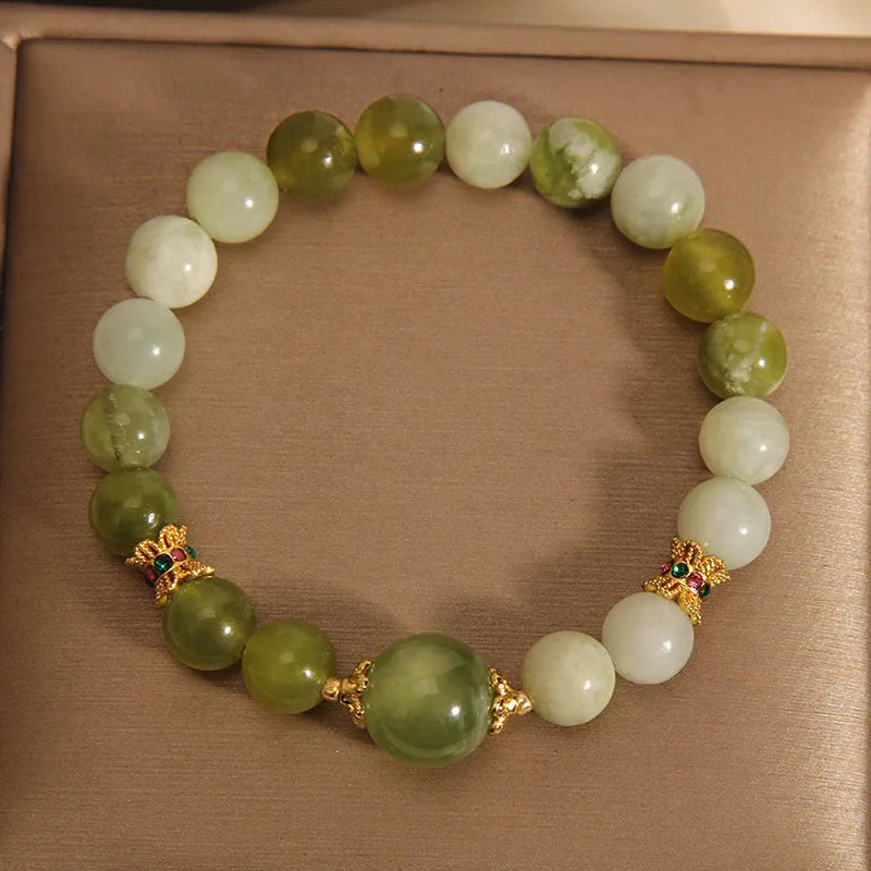 Women's bangle bracelet made from green Xiuyan jade stone with an original design.