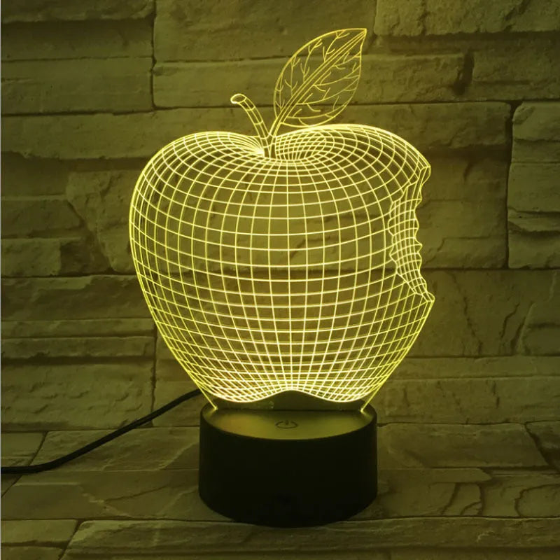 Colourful 3D fruit shaped night light with touch control on a table.