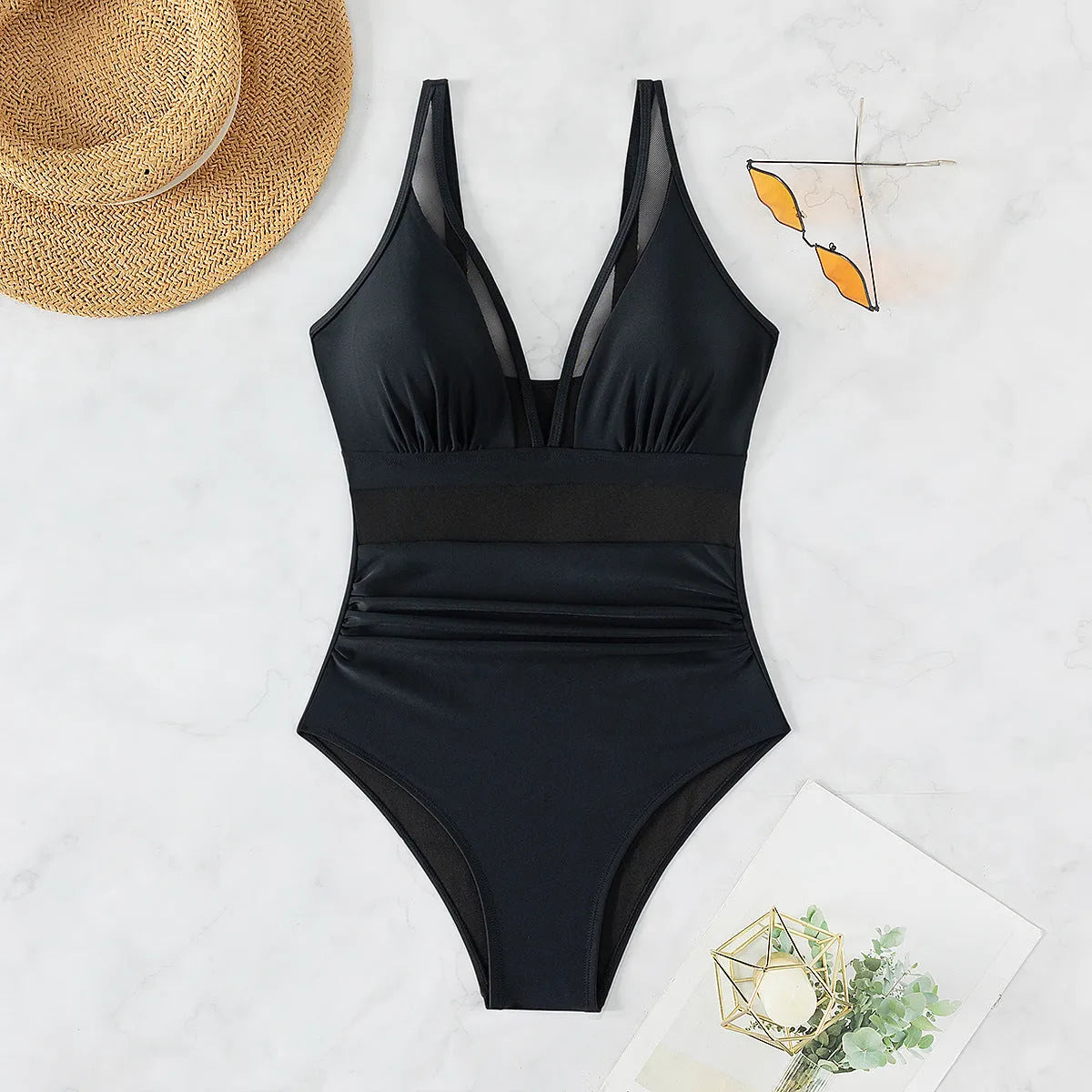 Black halter neck one-piece swimsuit with mesh detailing on adult female model