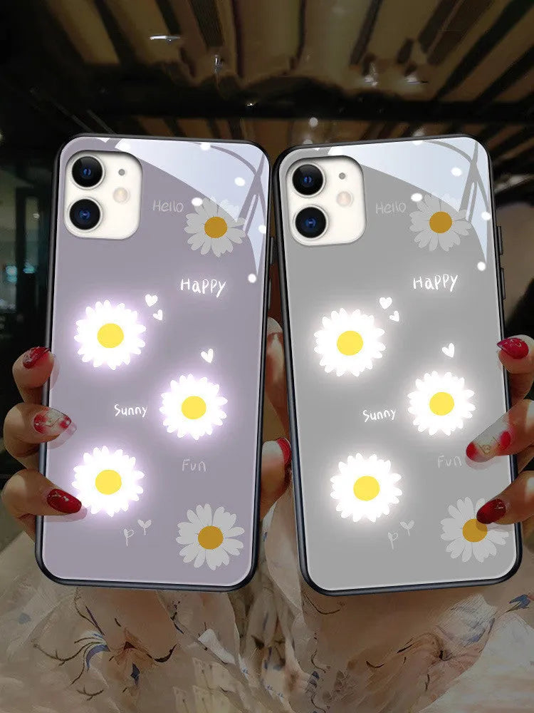 White luminous iPhone case with purple daisy design and voice-activated colour light on a table.