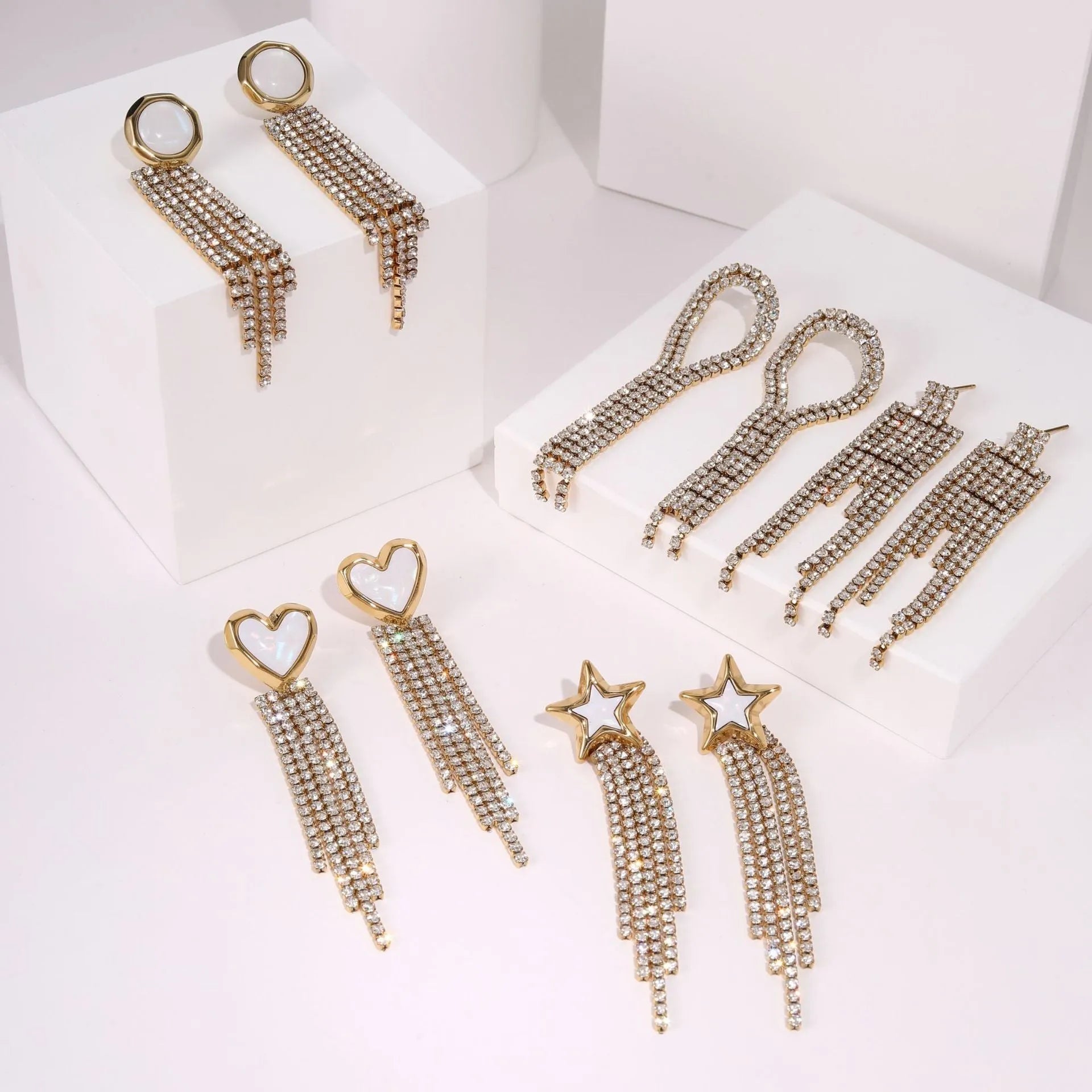 Gold plated stainless steel earrings with love heart and star geometric shapes and diamond tassel details