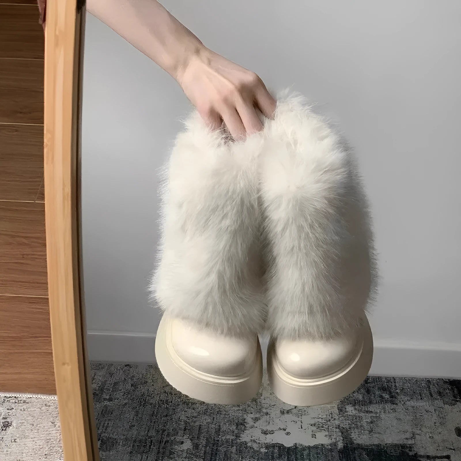Women's black artificial plush snow boots with a round toe, low-top design, and a mid rubber sole.