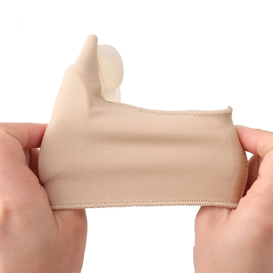 Corrective toe socks with silicone gel bunion pad and toe separator on a foot.