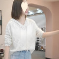 Women's light blue crochet knit hooded longsuit undershirt with long sleeves on a hanger.