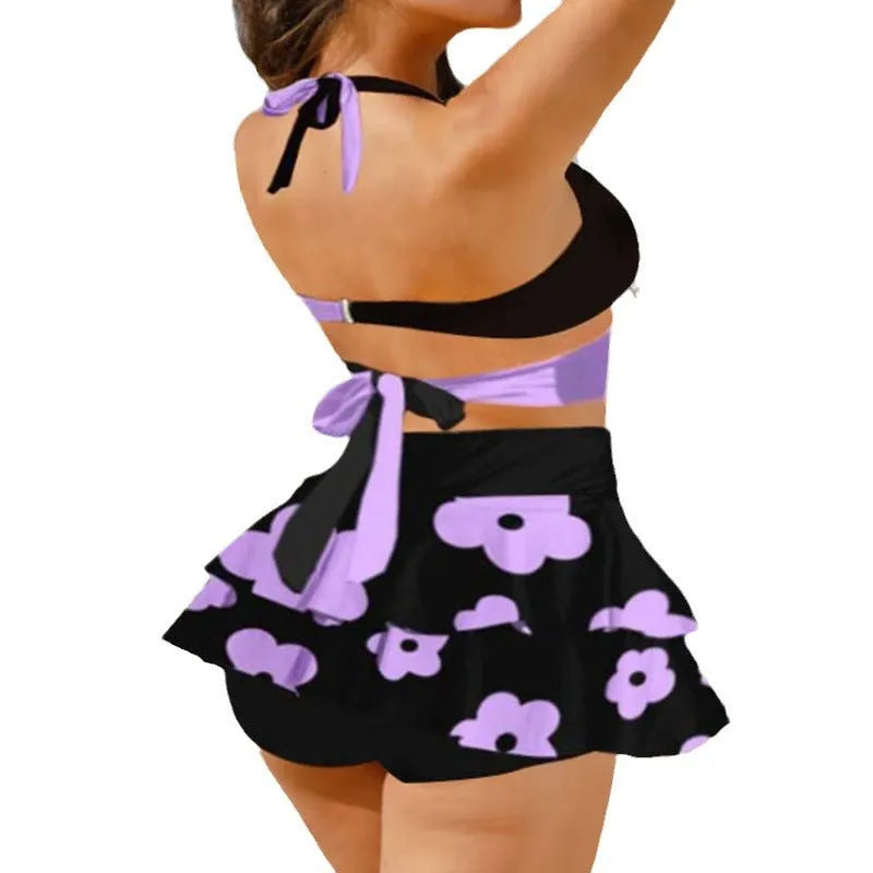 Women's black high-waisted bikini swimsuit with lace-up detail and matching skirt.