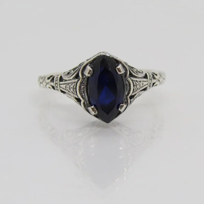 Women's geometric hollow ring in electroplated silver with zircon detail, showing openwork pattern