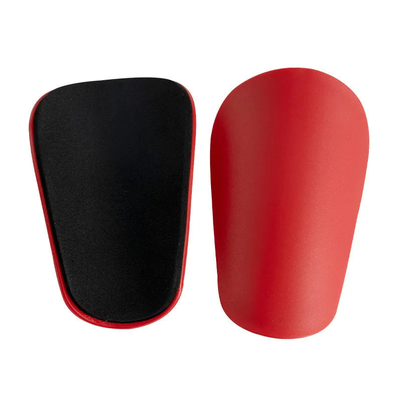 PU mini shin guards for football and sports protection in black, white, red, and blue colours.