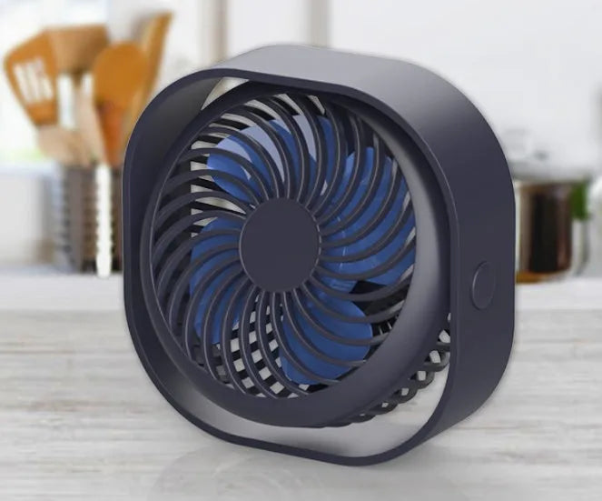 USB desk fan with rotating head in modern alarm clock style on a desk.
