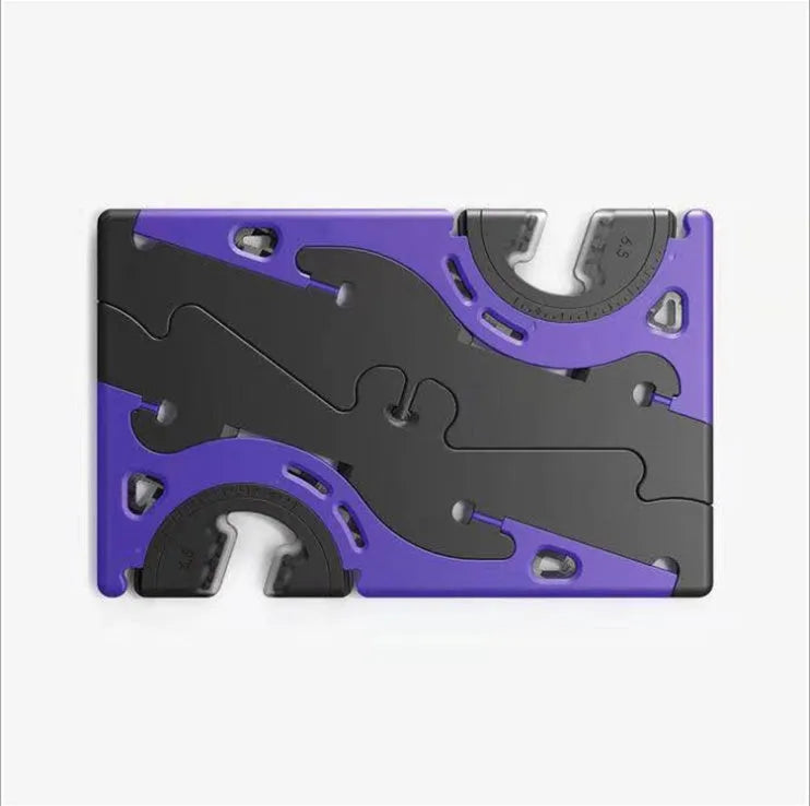 Black plastic card-type mobile phone holder propping a smartphone on a desktop